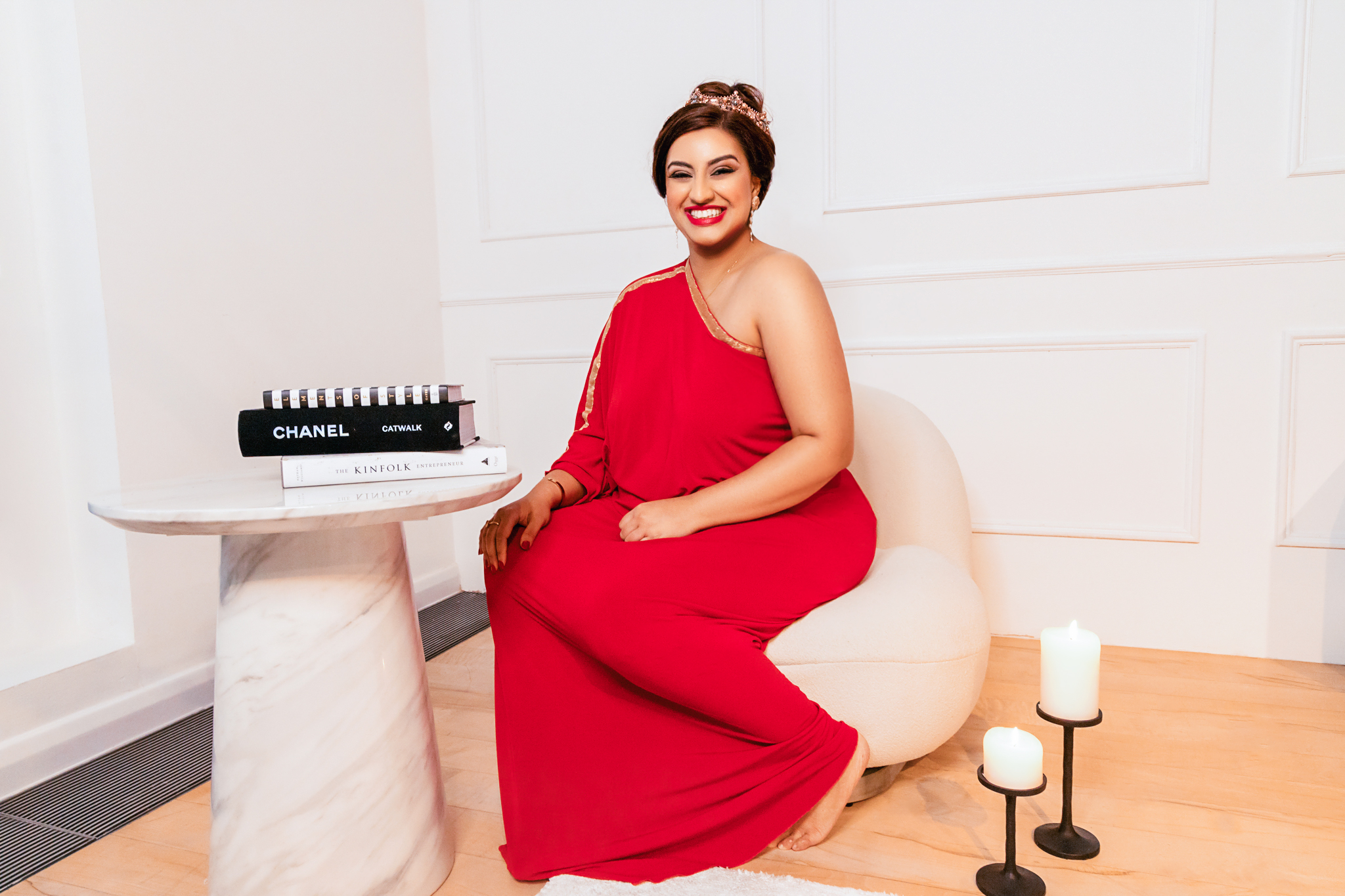 Lady in red dress sitting next to table