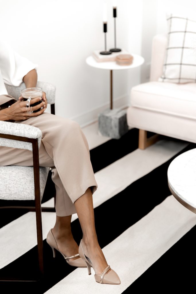 Lady on sofa holding coffee 
